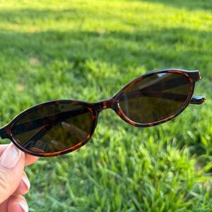 Brown tortoiseshell sunglasses with dark lenses